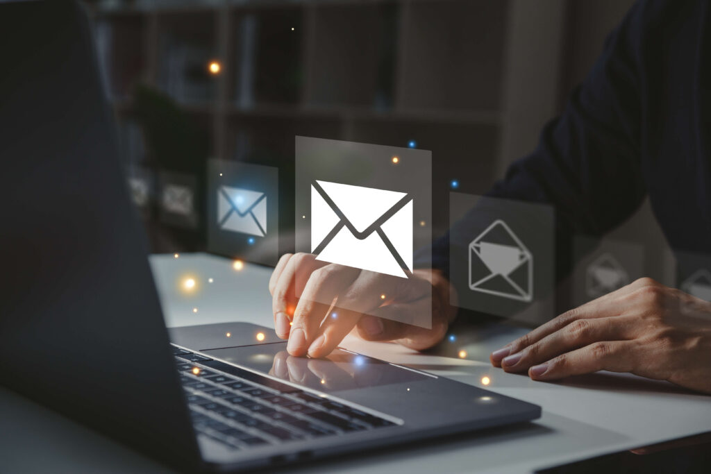 Person uses laptop touchpad with envelope icons superimposed